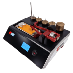 Benchtop laboratory testing instrument with a red lever frame and brass weight wheels on a black base.