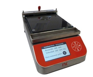 Compact bench-top laboratory device with a red front panel and a small digital display showing current parameters. The metal frame/rails suggest a measuring or testing instrument.
