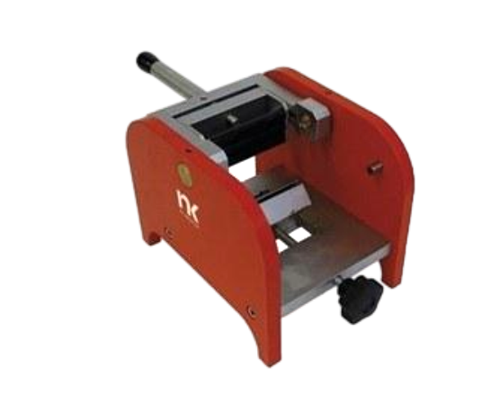 Red manual press tool with silver metal frame and black handle, shown from the side